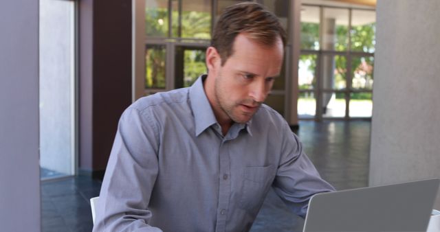 Businessman Concentrating on Laptop in Modern Office - Download Free Stock Images Pikwizard.com