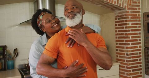 Senior African American Couple Embracing Joyfully in Kitchen - Download Free Stock Images Pikwizard.com
