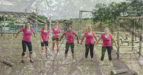 Women in Pink Athletic Wear Warming Up at Outdoor Fitness Course