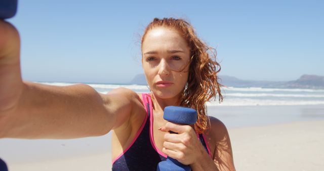 Determined Woman Exercising with Dumbbells on Beach - Download Free Stock Images Pikwizard.com