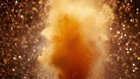 Explosive Golden Powder Cloud with Bokeh Sparkle Effect