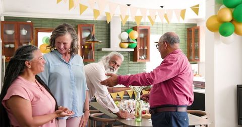 Senior friends joyfully gathering for festive dinner party
