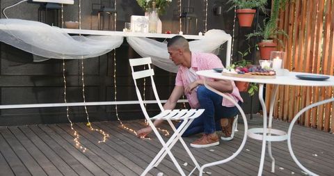 Setting Up Romantic Garden Patio with Fairy Lights for Dinner