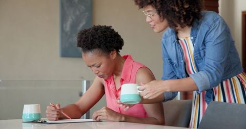 African american women discussing documents at home