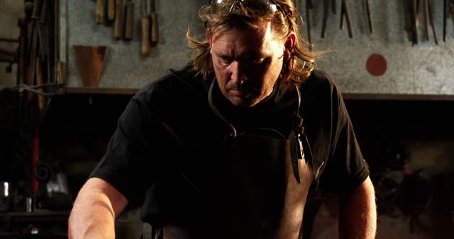 Male Blacksmith Working in Dimly Lit Workshop - Download Free Stock Images Pikwizard.com