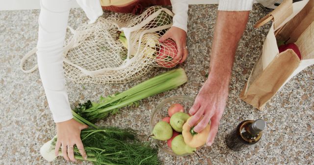 Hands Arranging Fresh Organic Vegetables and Fruits on Kitchen Table - Download Free Stock Images Pikwizard.com