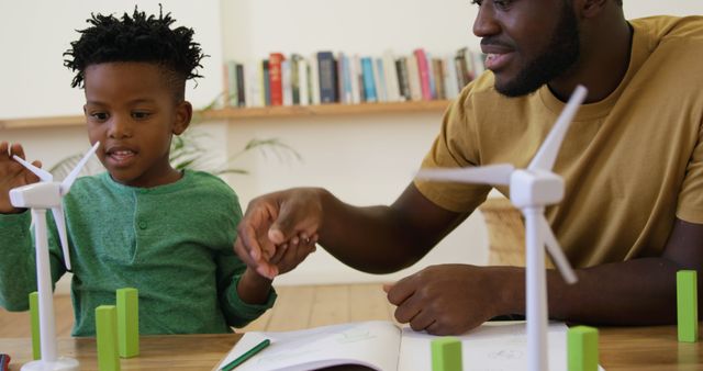 Father Teaching Child Science at Home with Wind Turbine Model - Download Free Stock Images Pikwizard.com