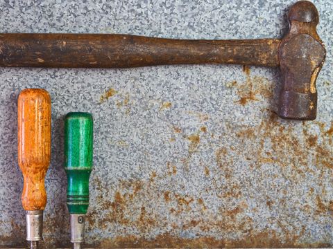 Rustic hand tools on metallic surface