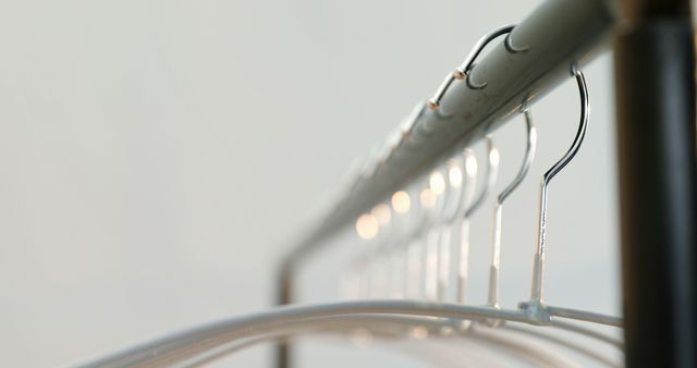 Row of Metal Hangers on Hanging Rod in Closet - Download Free Stock Images Pikwizard.com