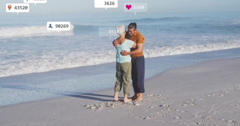 Senior Couple Embracing at Beach with Digital Social Media Overlays