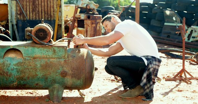 Man Restoring Vintage Machine in Outdoor Workshop - Download Free Stock Images Pikwizard.com