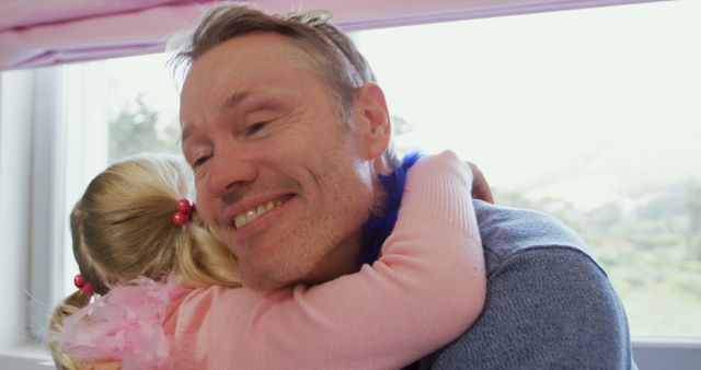 Father hugging daughter inside bright room - Download Free Stock Images Pikwizard.com