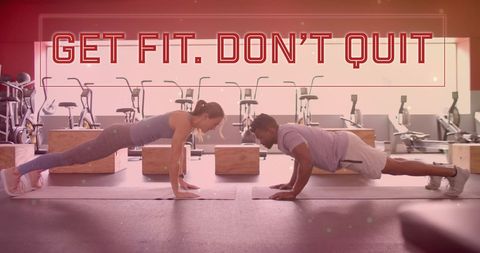 Motivational workout partners exercising in modern gym