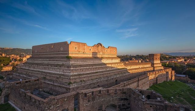 Ancient terraced stone bastion glowing in golden hour over historic ruins