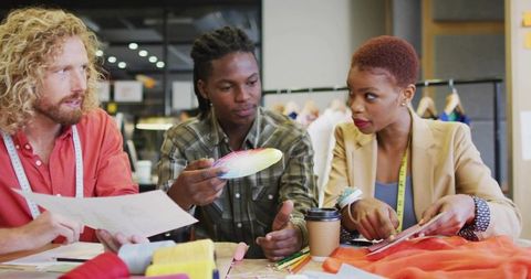 Fashion designers collaborating in creative design studio