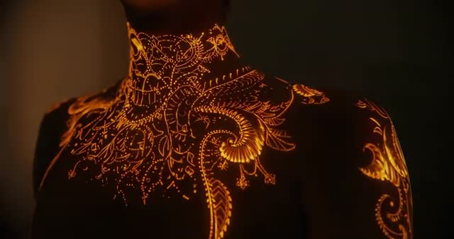 Mystical Golden Patterns Illuminating Female Torso in Artistic Display