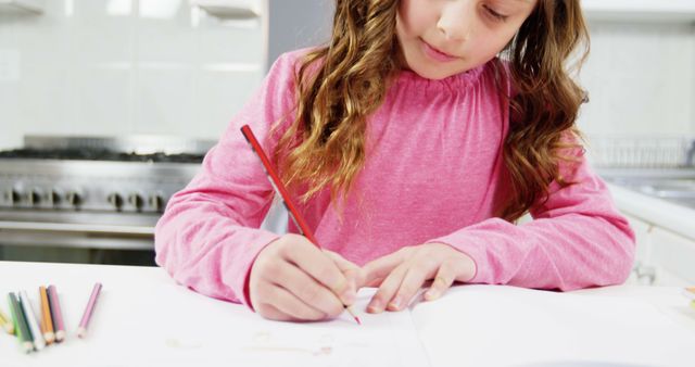 Young Girl Drawing with Colored Pencils in Kitchen - Download Free Stock Images Pikwizard.com