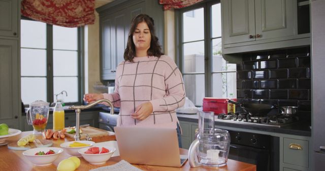 Woman Following Recipe on Laptop in Home Kitchen - Download Free Stock Images Pikwizard.com