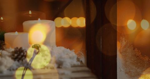 Warm Christmas Celebration with Lit Candles and Golden Lights