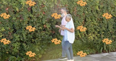 Mature couple walking and talking with floating dollar signs suggesting retirement finances