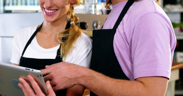 Baristas Discussing Orders on Digital Tablet in Coffee Shop - Download Free Stock Images Pikwizard.com