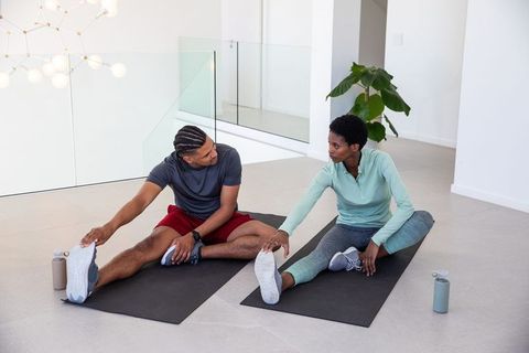 Fitness Partners Stretching in Bright Modern Gym for Flexible Wellness