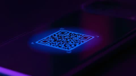 Pulsing Neon QR Code Scanning on Smartphone Screen Macro Video in Blue Purple Cyber Glow
