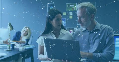 Collaborative Teamwork in Modern Office with Futuristic Technology Display