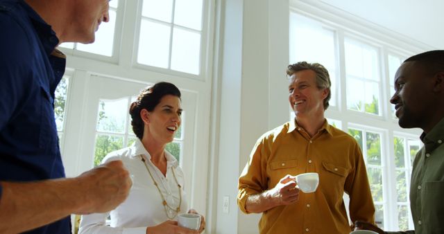 Diverse Colleagues Enjoying Coffee Break in Well-lit Modern Office - Download Free Stock Images Pikwizard.com