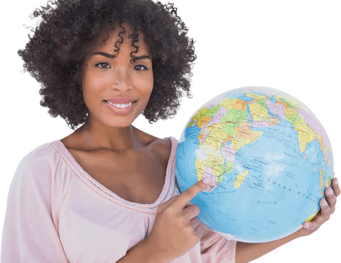 Cheerful young woman pointing at transparent globe