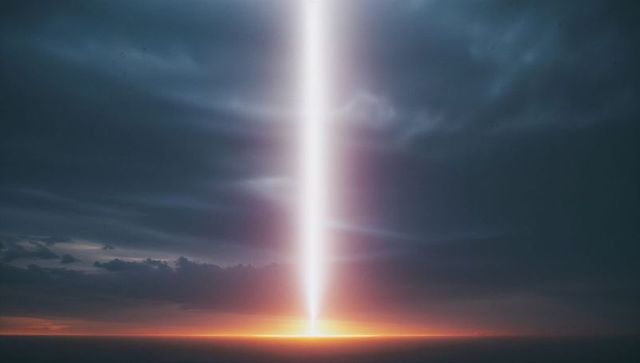 Ethereal vertical light beam highlighting ocean at dusk