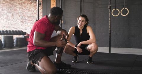 Personal Trainer Consulting Client at Industrial Gym with Battle Ropes