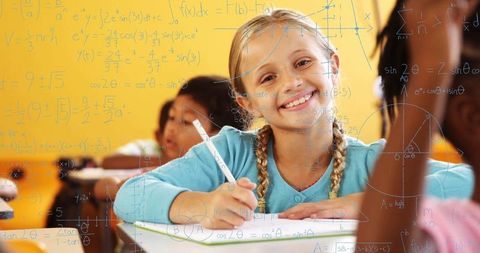 Smiling Girl Enthusiastically Engaged in Classroom Learning