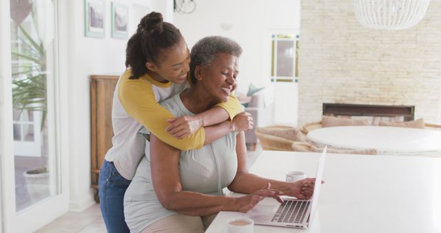 Happy African American Mother and Daughter Using Laptop at Home - Download Free Stock Images Pikwizard.com