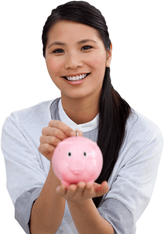 Smiling asian businesswoman holding transparent piggy bank