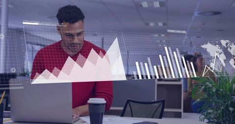 Man Leaning Over Laptop Analyzing Holographic Data Visualizations in Modern Open Office