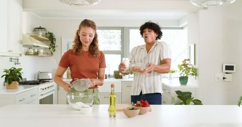 Diverse Couple Enjoying Baking in Bright Modern Kitchen