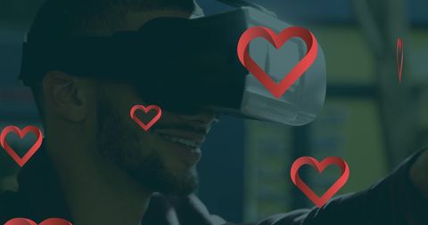 Smiling Man Using Virtual Reality Headset with Red Hearts Overlay - Download Free Stock Images Pikwizard.com