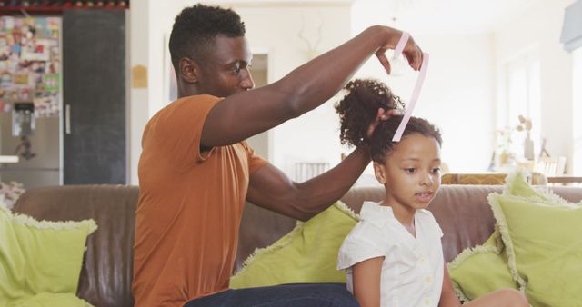 Father Styling Daughter's Hair at Home on Sofa - Download Free Stock Images Pikwizard.com