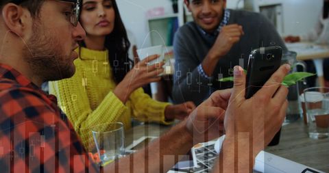 Colleagues Discussing Data Analysis in Modern Office