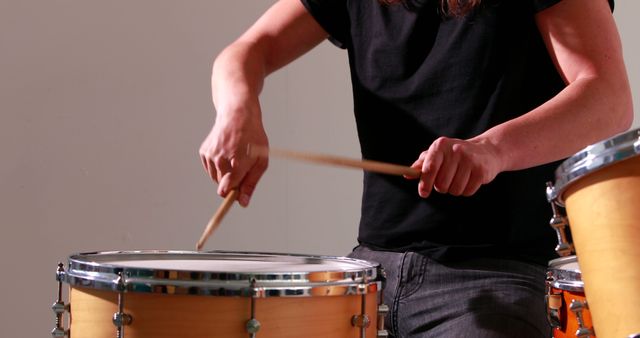 Drummer playing his drum kit in the studio