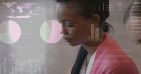 Biracial businesswoman analyzing digital data on tablet