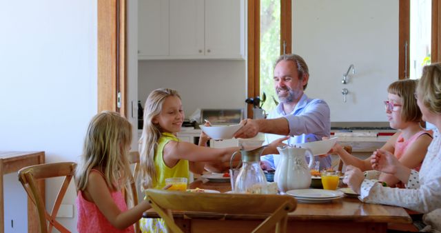 Family Enjoying Breakfast Together at Home in Sunny Kitchen - Download Free Stock Images Pikwizard.com