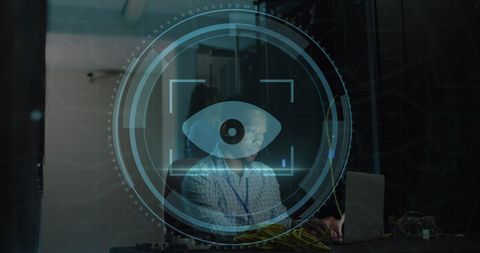 Engineer working in server room with digital eye scanner overlay