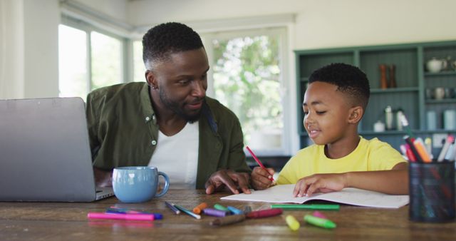 Father helping son with homework at home office desk - Download Free Stock Images Pikwizard.com