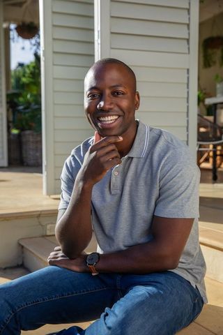 Confident man enjoying outdoor leisure on porch steps