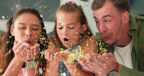 Joyful Family Celebrating Birthday with Colorful Confetti