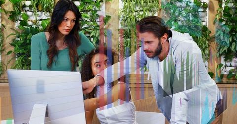 Team Analyzing Data Collaboratively on Office Monitor