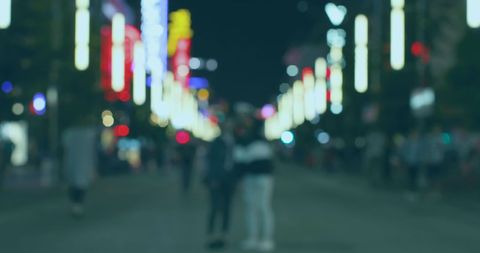 Blurred City Lights with Evening Pedestrians on Vibrant Street