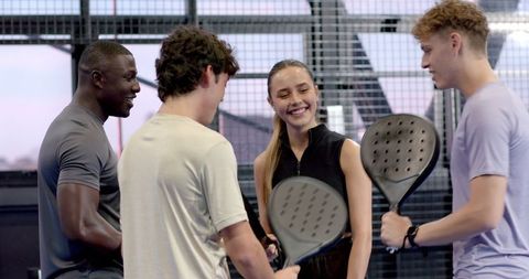 Diverse group of friends enjoying padel match together